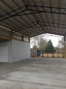 A barn with steel trusses and a metal roof.