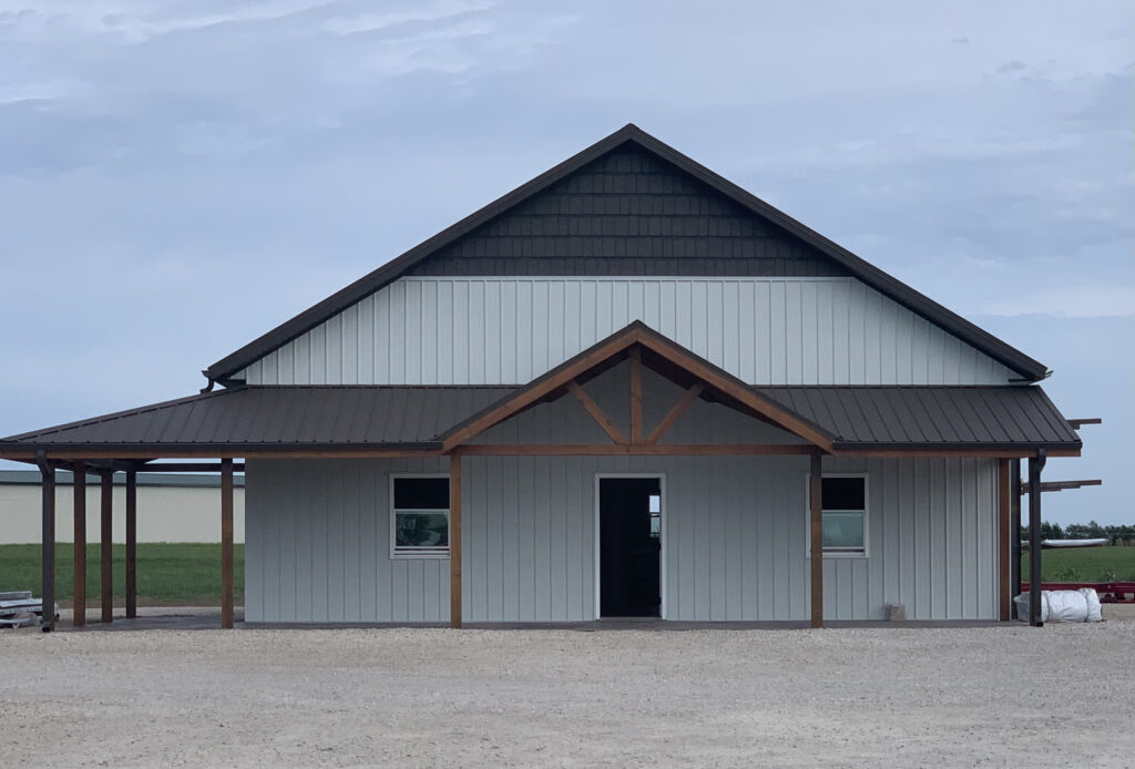 A metal roof and siding barn with steel trusses.