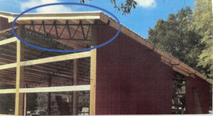 A picture of a barn with a blue circle on it.