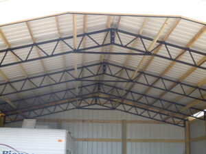 The roof of a garage with a rv in it.