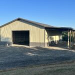 A metal building with a garage attached to it.