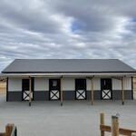 A barn with two doors and a roof.