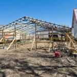 A wooden frame is being built in a yard.